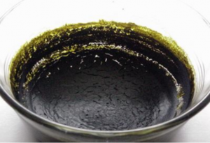 Crude ethanol extract in a bowl, showing lots of co-extracted compounds